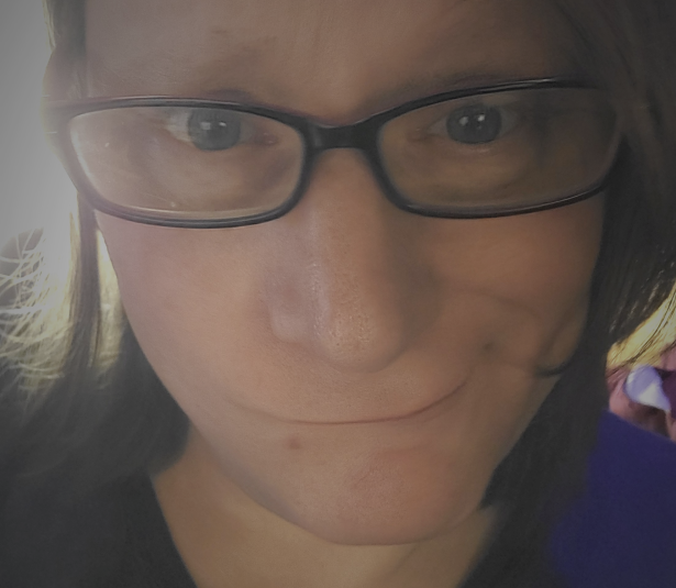 Katt with her lips awkwardly puckered, with a very confused and worried look on her face